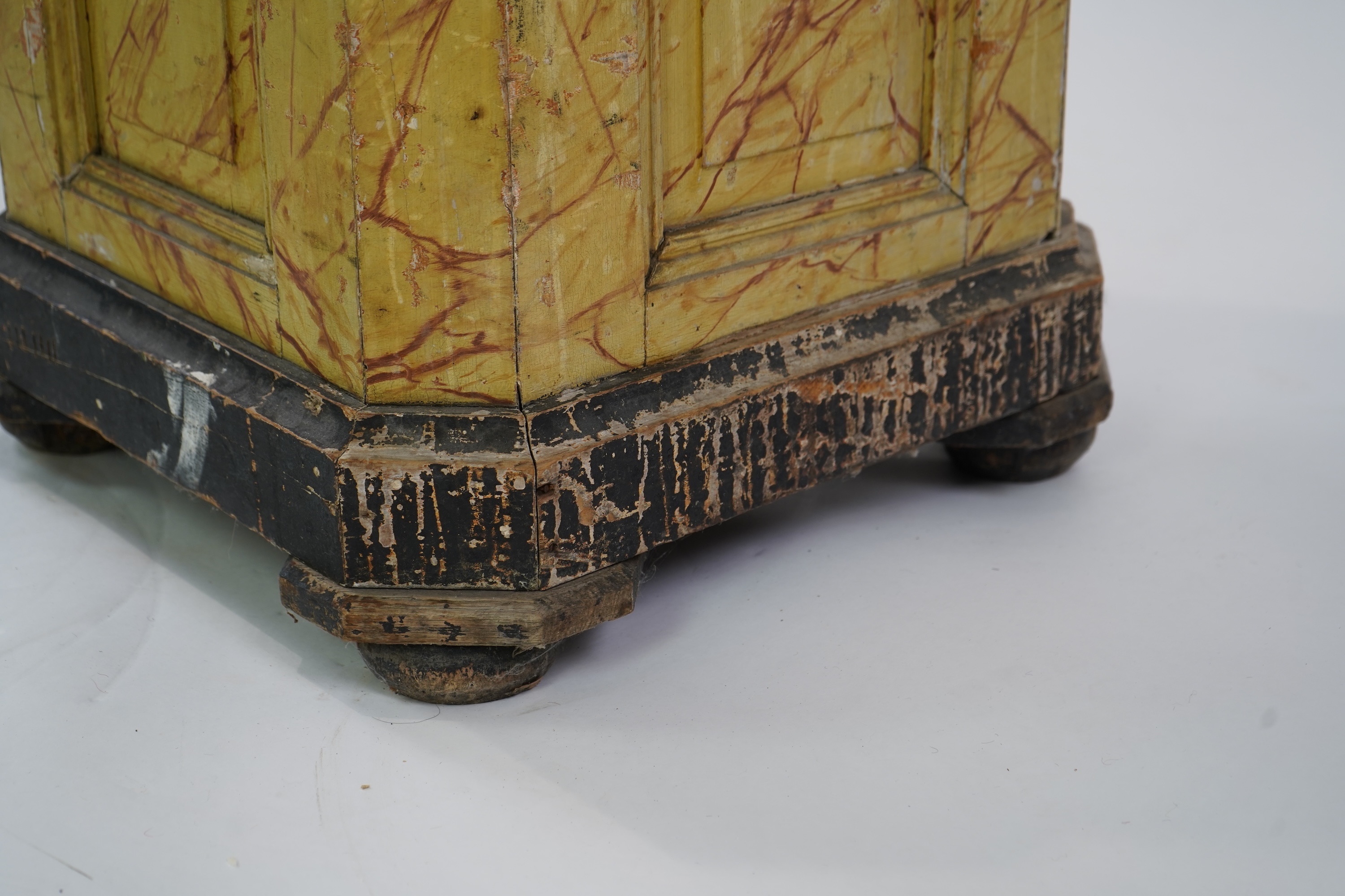 A Victorian white painted cast iron urn and a painted faux marble pedestal